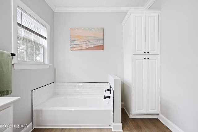 full bath featuring wood finished floors, a bath, crown molding, and vanity
