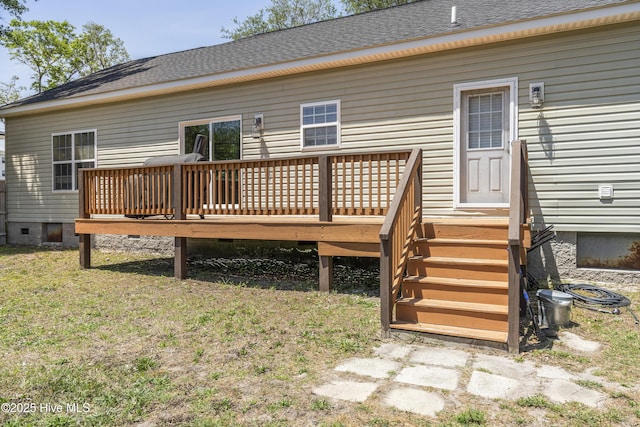 rear view of property with a deck, crawl space, and a shingled roof