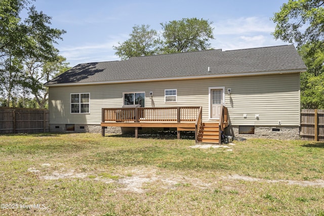 back of property with crawl space, a deck, and a shingled roof