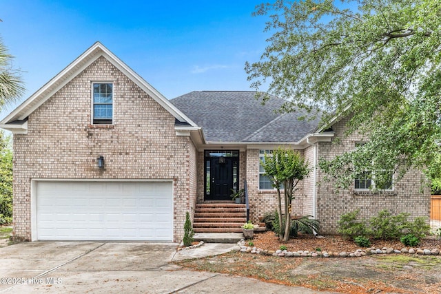 view of front of home with brick siding, concrete driveway, and a shingled roof