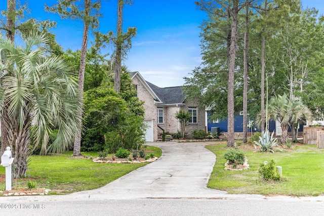 view of front facade with asphalt driveway, brick siding, a front yard, and a garage