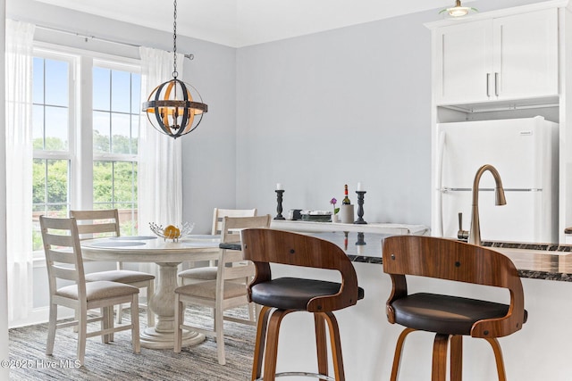 dining area with a chandelier and plenty of natural light