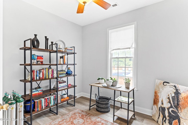 home office with baseboards, wood finished floors, and ceiling fan