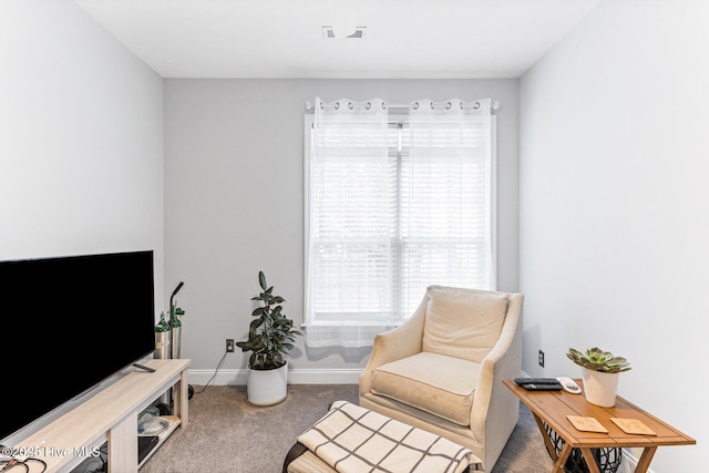 sitting room featuring carpet and baseboards