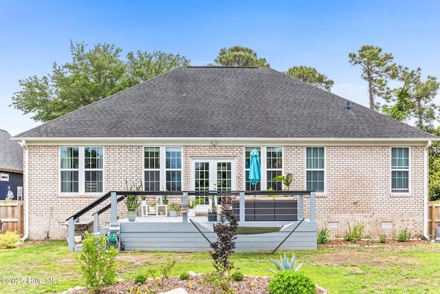 back of house featuring crawl space, roof with shingles, brick siding, and a wooden deck