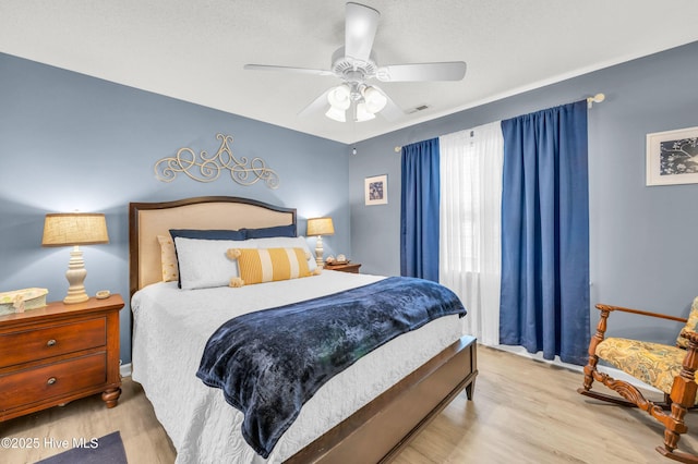bedroom featuring wood finished floors and a ceiling fan