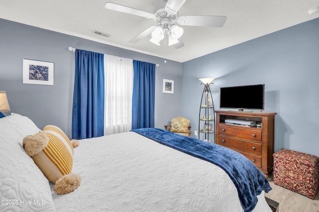bedroom featuring a ceiling fan and wood finished floors