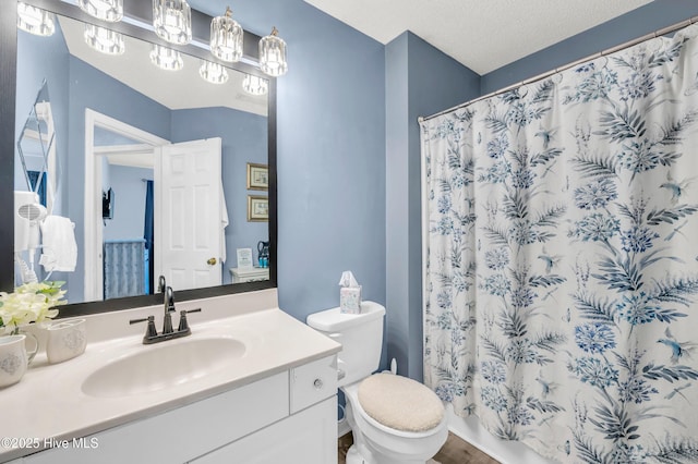 full bathroom featuring vanity, toilet, curtained shower, and wood finished floors