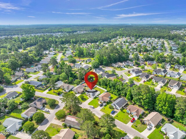 aerial view of property and surrounding area featuring nearby suburban area