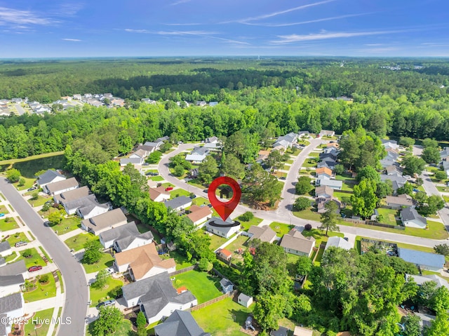 aerial view of residential area featuring a forest