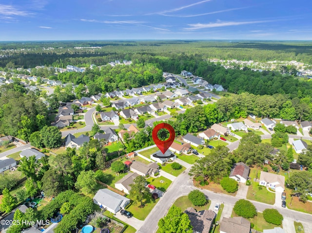 aerial overview of property's location featuring a heavily wooded area and nearby suburban area