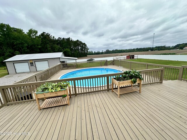 146 N Ravenwood Ln, Belhaven, NC 27810 - view of swimming pool featuring a deck, a fenced backyard, and an outdoor structure