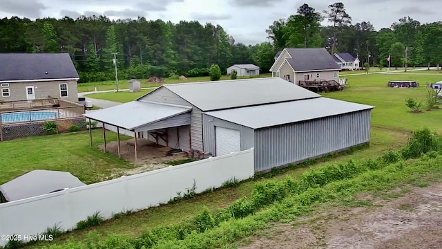 146 N Ravenwood Ln, Belhaven, NC 27810 - view of property exterior with an outdoor structure, an outbuilding, and a wooded view