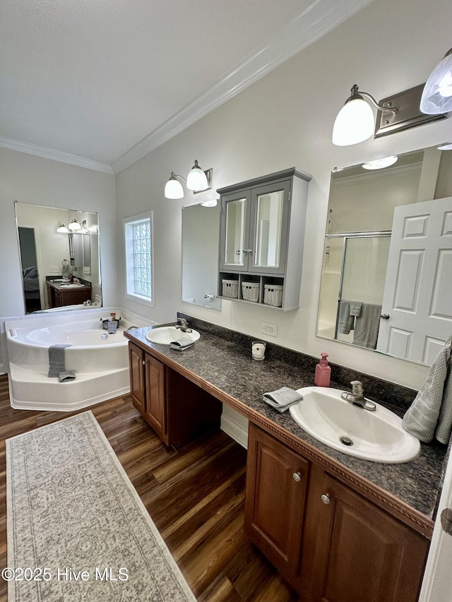146 N Ravenwood Ln, Belhaven, NC 27810 - bathroom featuring wood finished floors, crown molding, a stall shower, a garden tub, and double vanity