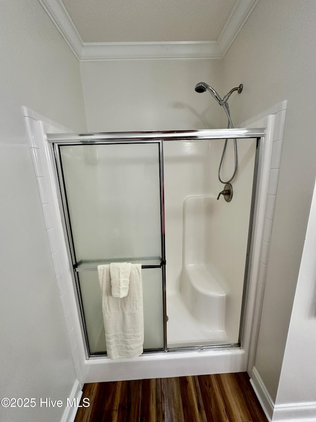 146 N Ravenwood Ln, Belhaven, NC 27810 - bathroom with crown molding, a shower stall, and wood finished floors