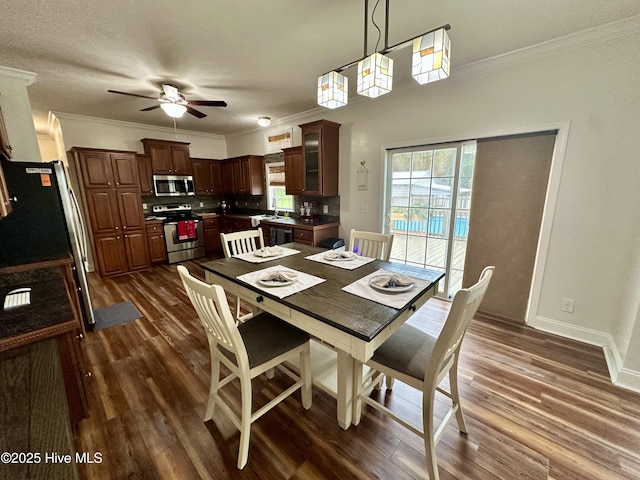 146 N Ravenwood Ln, Belhaven, NC 27810 - dining room featuring ornamental molding, dark wood-style floors, ceiling fan, and baseboards