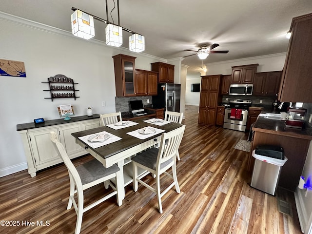 146 N Ravenwood Ln, Belhaven, NC 27810 - dining space with ceiling fan, dark wood-style floors, ornamental molding, and baseboards