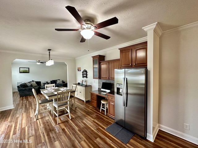 146 N Ravenwood Ln, Belhaven, NC 27810 - kitchen featuring stainless steel fridge with ice dispenser, a ceiling fan, dark wood finished floors, ornamental molding, and arched walkways