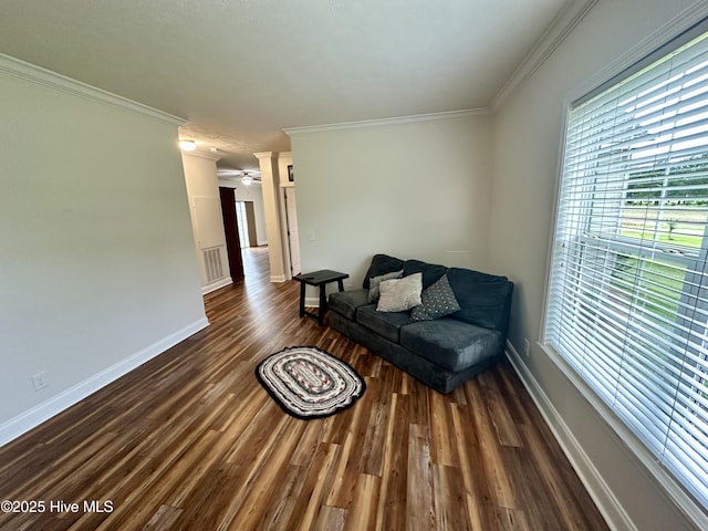 146 N Ravenwood Ln, Belhaven, NC 27810 - living room with crown molding, healthy amount of natural light, dark wood-type flooring, and baseboards