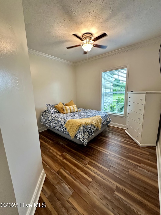 146 N Ravenwood Ln, Belhaven, NC 27810 - bedroom with ornamental molding, a textured ceiling, wood finished floors, baseboards, and ceiling fan