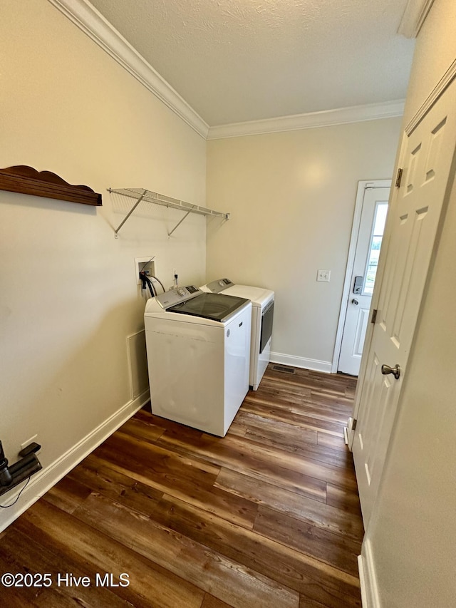 146 N Ravenwood Ln, Belhaven, NC 27810 - laundry area with crown molding, washing machine and dryer, dark wood-style floors, and baseboards