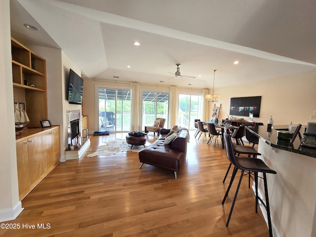 105 Argosy Dr, New Bern, NC 28560 - living room featuring a fireplace with raised hearth, light wood finished floors, a ceiling fan, recessed lighting, and lofted ceiling