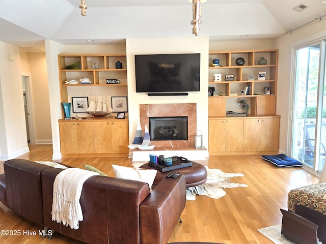 105 Argosy Dr, New Bern, NC 28560 - living room with lofted ceiling, wood finished floors, a fireplace, and built in shelves