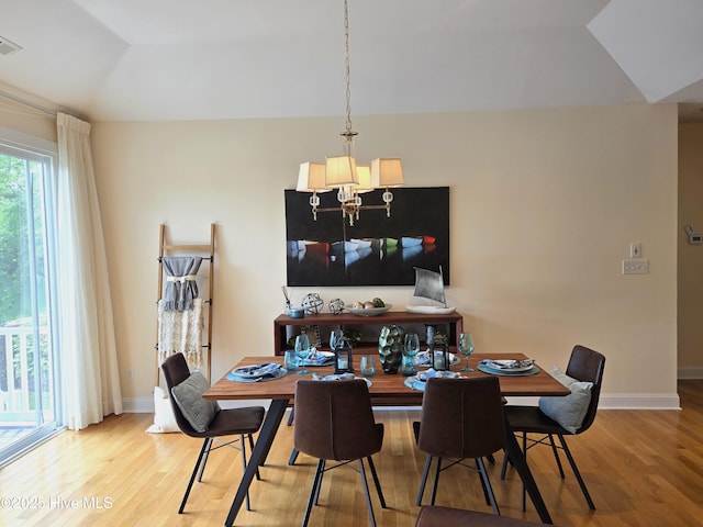 105 Argosy Dr, New Bern, NC 28560 - dining area featuring light wood-style flooring, a chandelier, vaulted ceiling, and baseboards