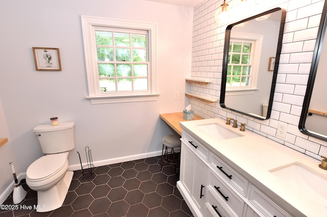 bathroom with decorative backsplash, toilet, tile patterned flooring, baseboards, and double vanity