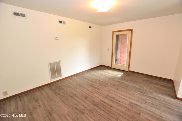 unfurnished room with wood finished floors and baseboards