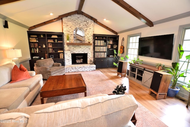 living room featuring wood finished floors, a large fireplace, and ornamental molding