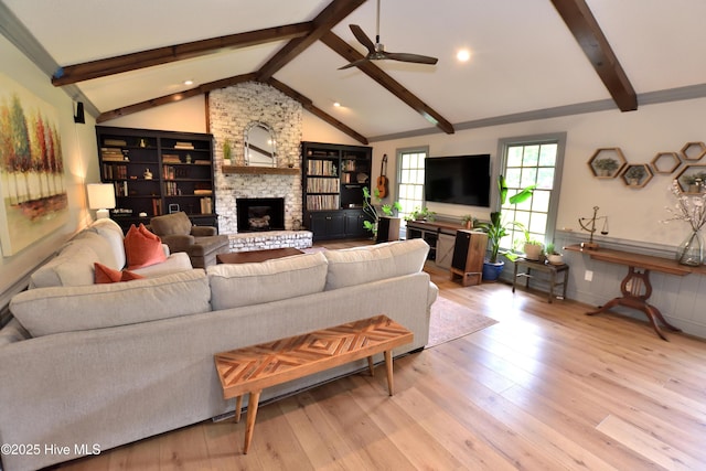 living area featuring a fireplace, a ceiling fan, wood finished floors, and recessed lighting