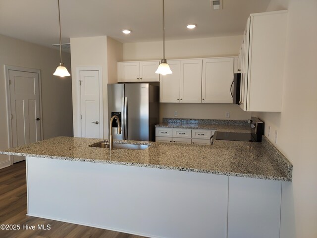 97 Hadnot Dr Unit B, Swansboro, NC 28584 - kitchen with appliances with stainless steel finishes, a sink, light stone countertops, dark wood-type flooring, and white cabinets