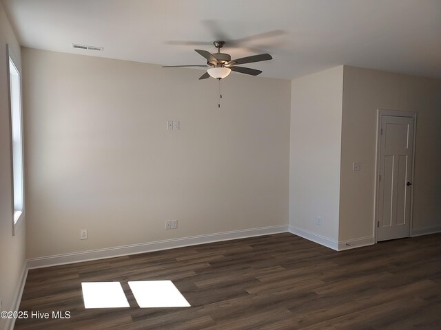 97 Hadnot Dr Unit B, Swansboro, NC 28584 - empty room with dark wood finished floors, ceiling fan, and baseboards