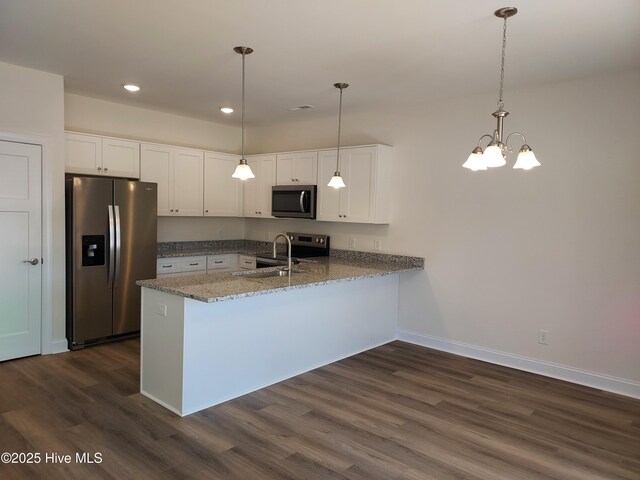 97 Hadnot Dr Unit B, Swansboro, NC 28584 - kitchen with stainless steel appliances, a peninsula, dark wood finished floors, white cabinetry, and recessed lighting