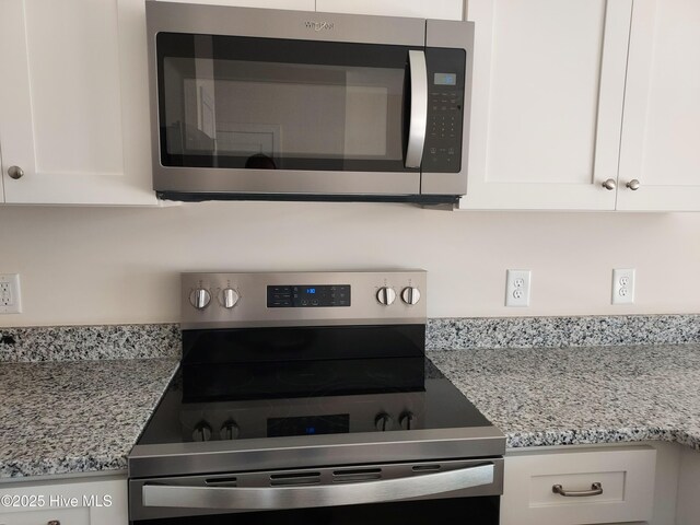97 Hadnot Dr Unit B, Swansboro, NC 28584 - kitchen view of appliances with stainless steel finishes, white cabinets, and light stone counters