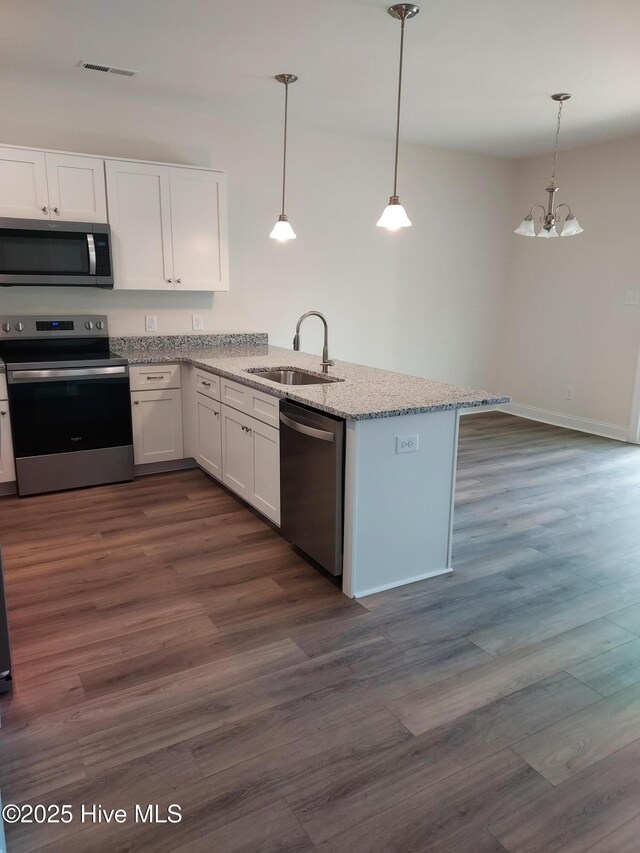 97 Hadnot Dr Unit B, Swansboro, NC 28584 - kitchen featuring appliances with stainless steel finishes, a sink, white cabinets, and light stone countertops