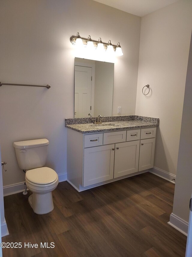 97 Hadnot Dr Unit B, Swansboro, NC 28584 - bathroom featuring wood finished floors, baseboards, toilet, and vanity