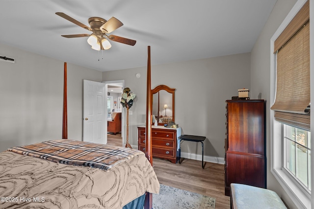 bedroom with wood finished floors, baseboards, and a ceiling fan