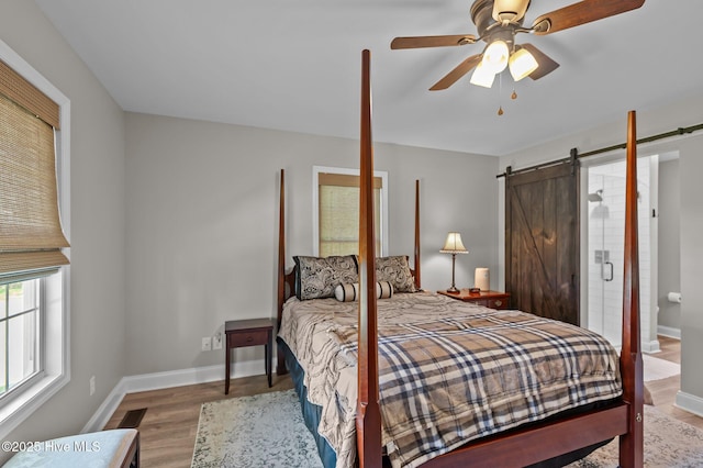 bedroom with wood finished floors, baseboards, and a ceiling fan