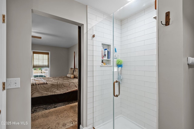 ensuite bathroom featuring a stall shower and wood finished floors