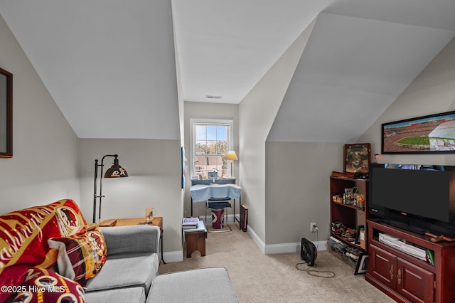 living area with carpet, baseboards, and vaulted ceiling