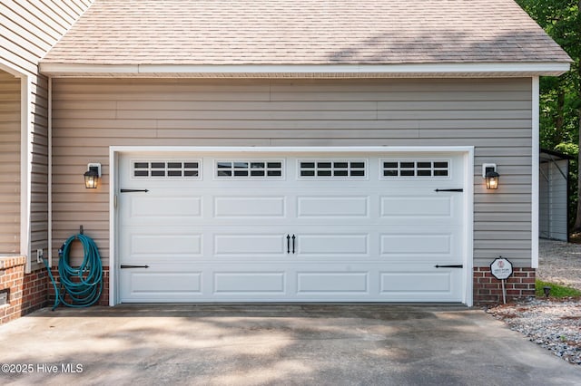 garage featuring concrete driveway