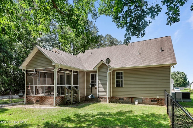 rear view of house with crawl space, a sunroom, and roof with shingles