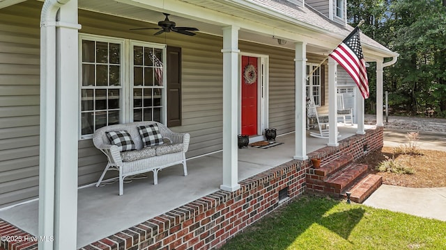 entrance to property with covered porch and ceiling fan