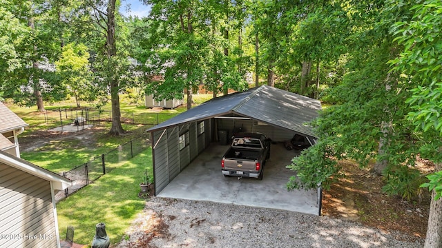 view of parking with driveway and a carport