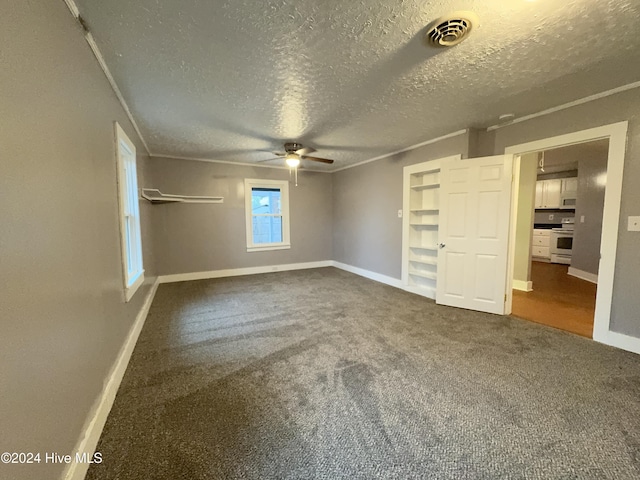 909 4th St, Elizabeth City, NC 27909 - unfurnished bedroom with dark carpet, baseboards, a textured ceiling, a closet, and ceiling fan