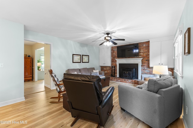 209 Inlet Dr, Wilmington, NC 28411 - living area featuring a ceiling fan, a fireplace, light wood-type flooring, and baseboards