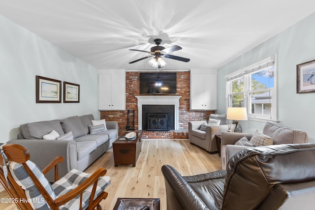 209 Inlet Dr, Wilmington, NC 28411 - living room featuring light wood-type flooring, a ceiling fan, and a large fireplace