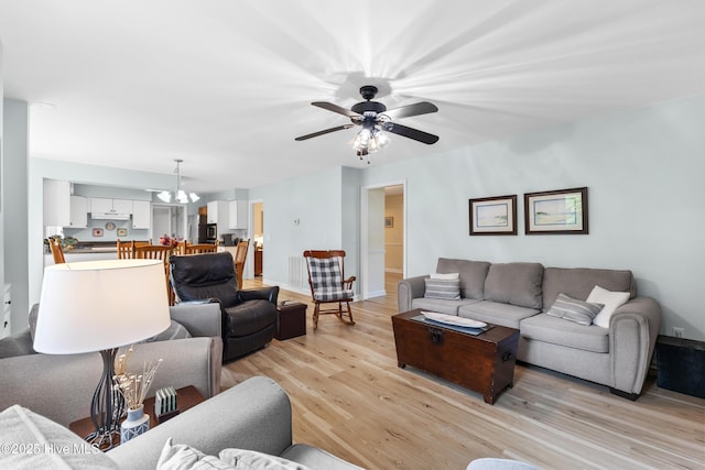 209 Inlet Dr, Wilmington, NC 28411 - living area with light wood-style flooring, a chandelier, a ceiling fan, and baseboards